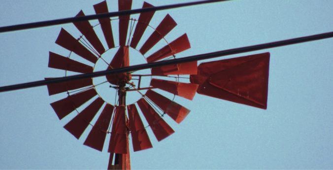 A close up of the top of an old windmill.